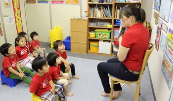ESL teacher reading to children in Japan.