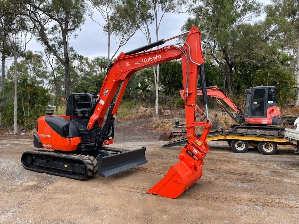A Yellow and Black Excavator is Digging a Hole in a Dirt Field — Eddy’s Excavations & Bobcat Hire In Wurdong Heights, QLD