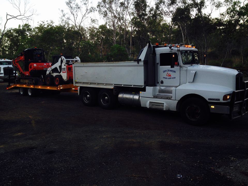 A Dump Truck is Being Loaded With Dirt by a Bulldozer — Eddy’s Excavations & Bobcat Hire In Wurdong Heights, QLD