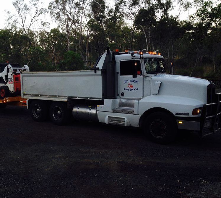 A Dump Truck is Being Loaded With Dirt by a Bulldozer — Eddy’s Excavations & Bobcat Hire In Wurdong Heights, QLD