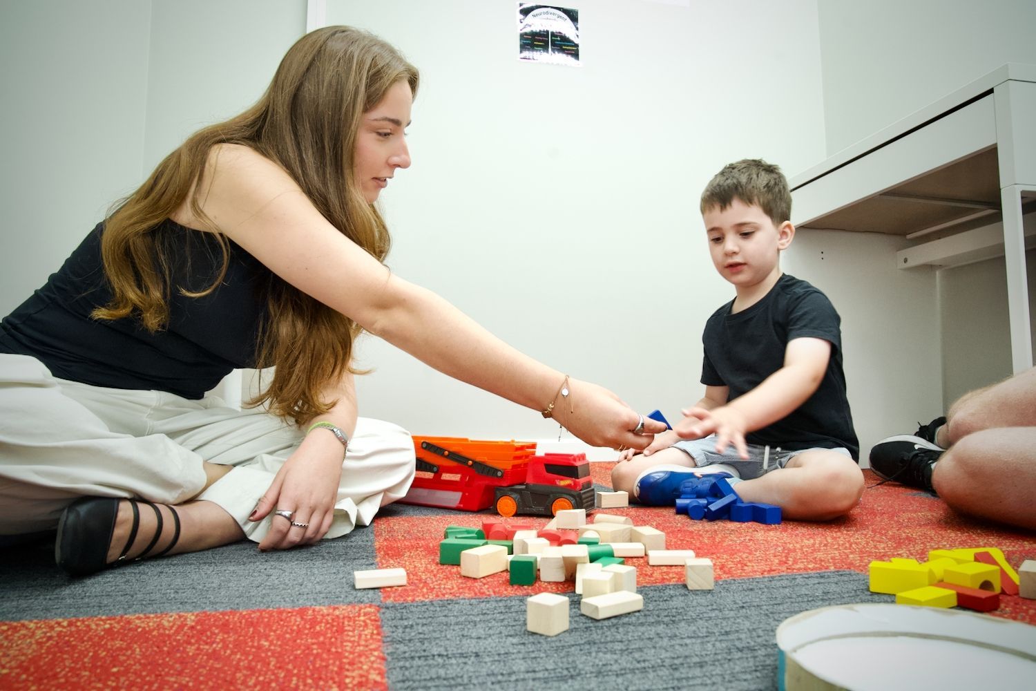 A woman is talking to a man in a gym.
