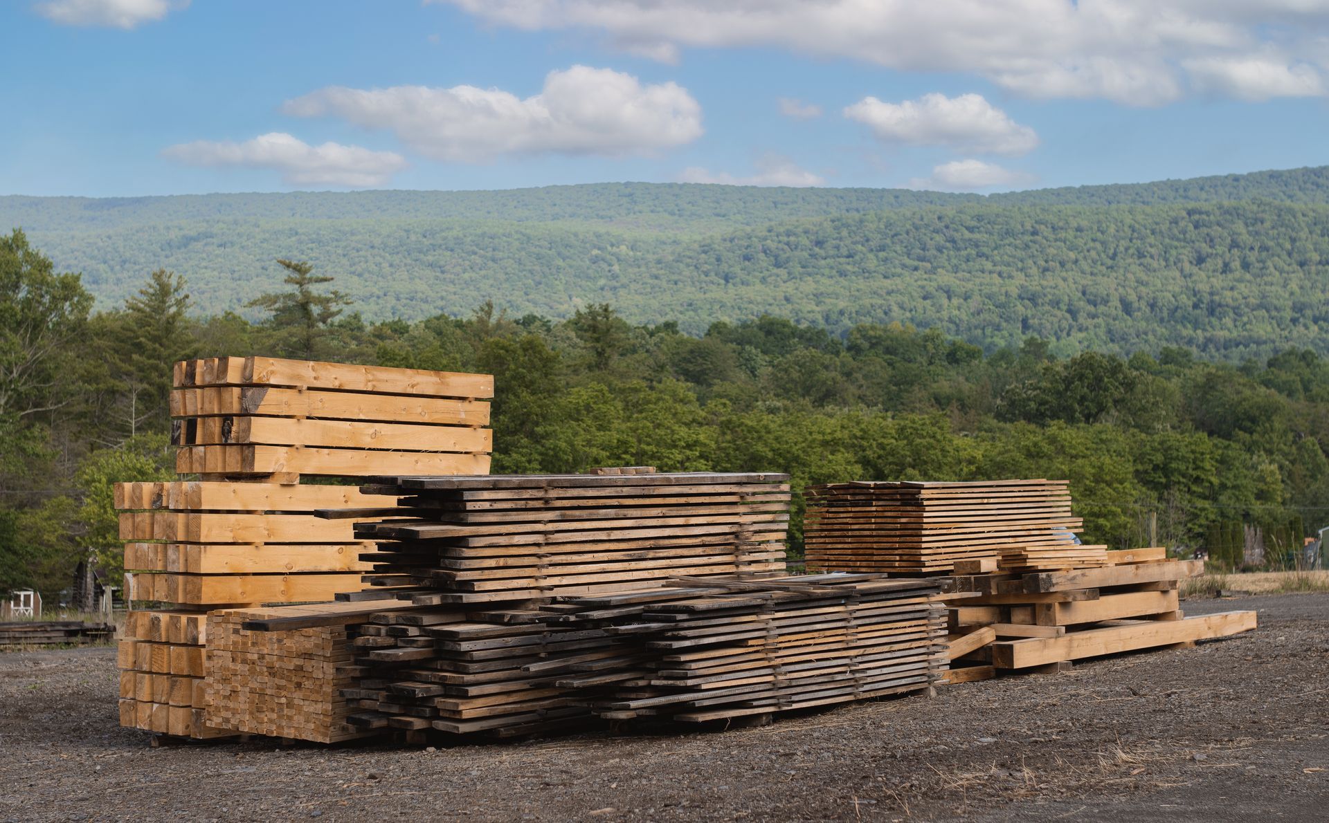 A pile of wood is stacked on top of each other in a field.
