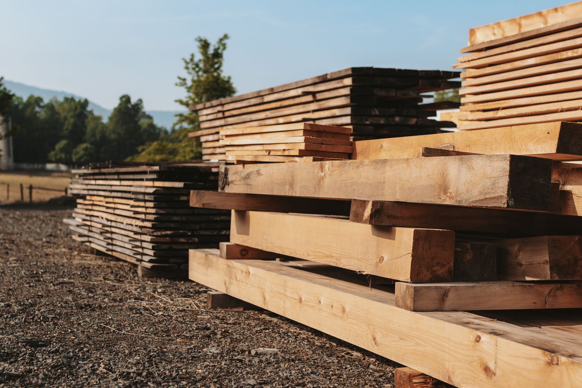 A pile of wood is stacked on top of each other in a field.