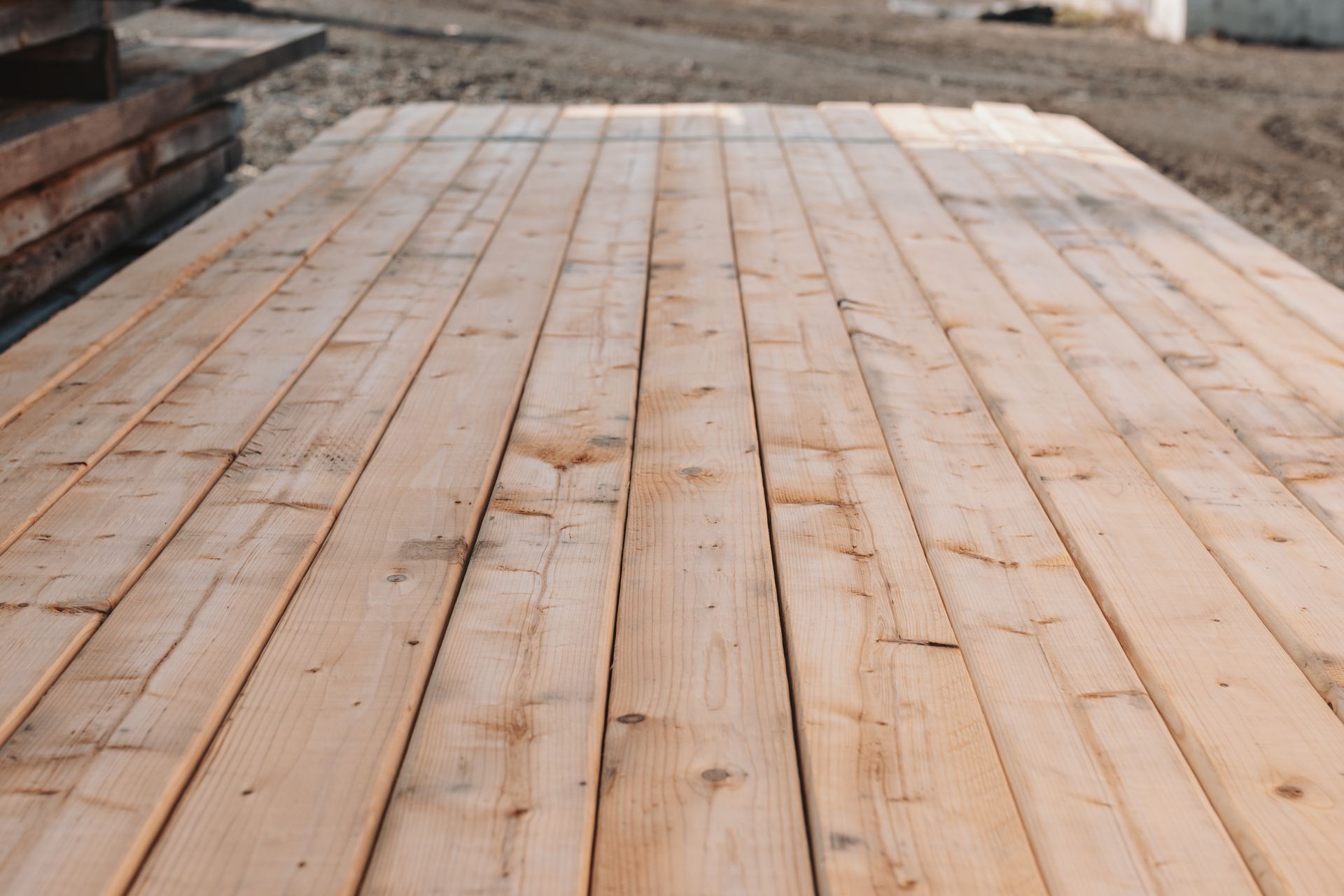 A wooden deck is sitting on top of a pile of wood.