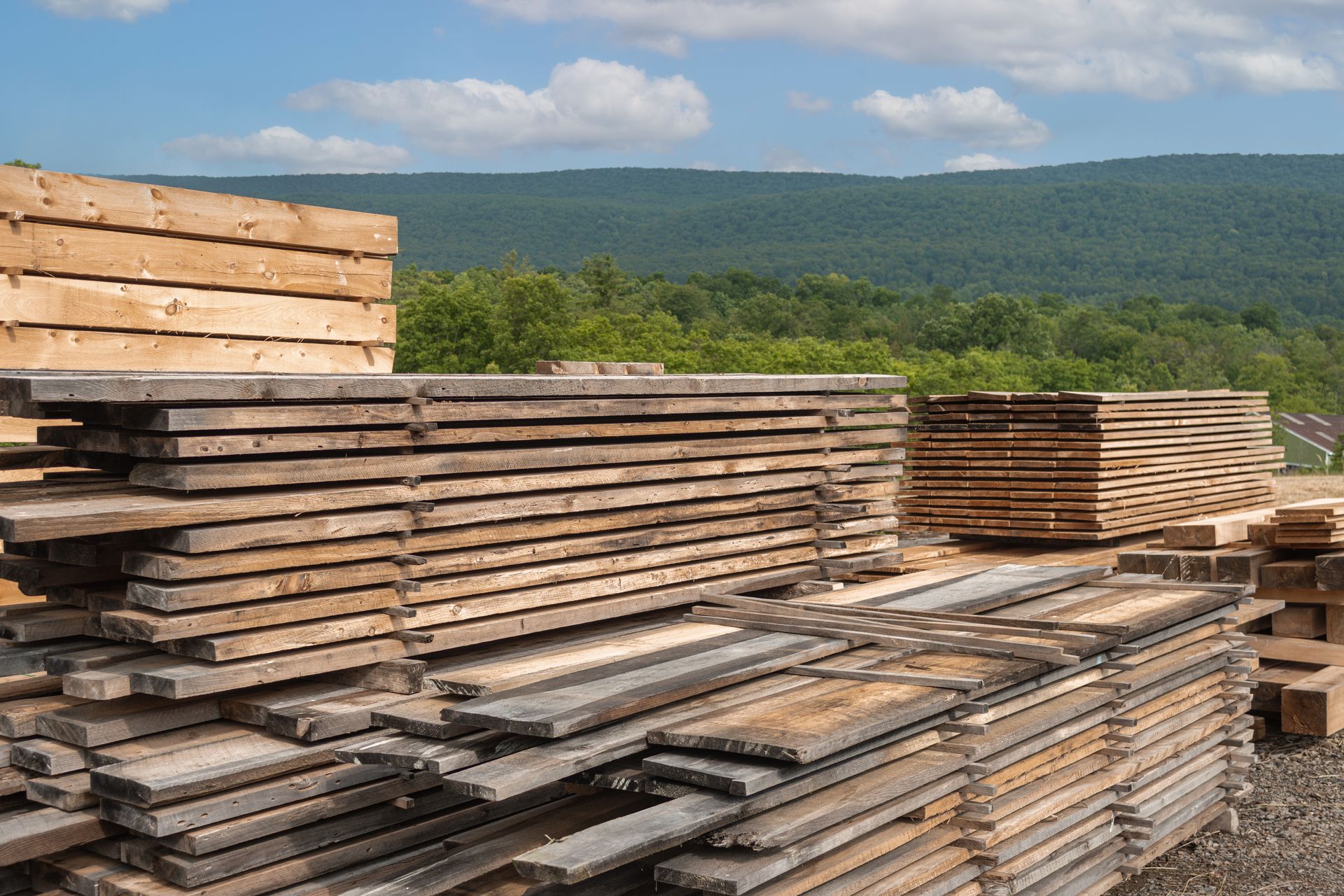 A pile of wood is stacked on top of each other in a field.
