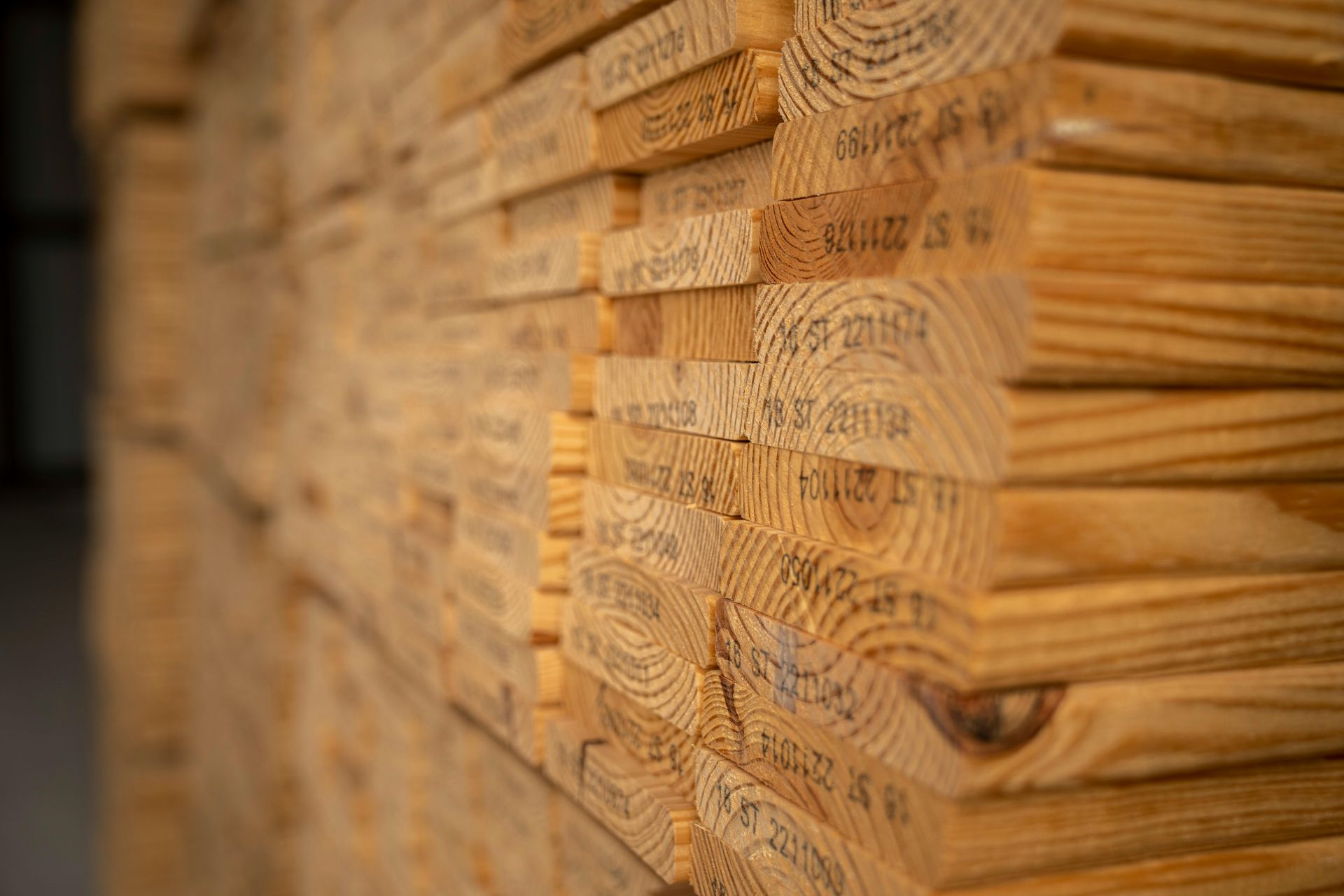 Stack of lumber with visible wood grain and printed stamps.