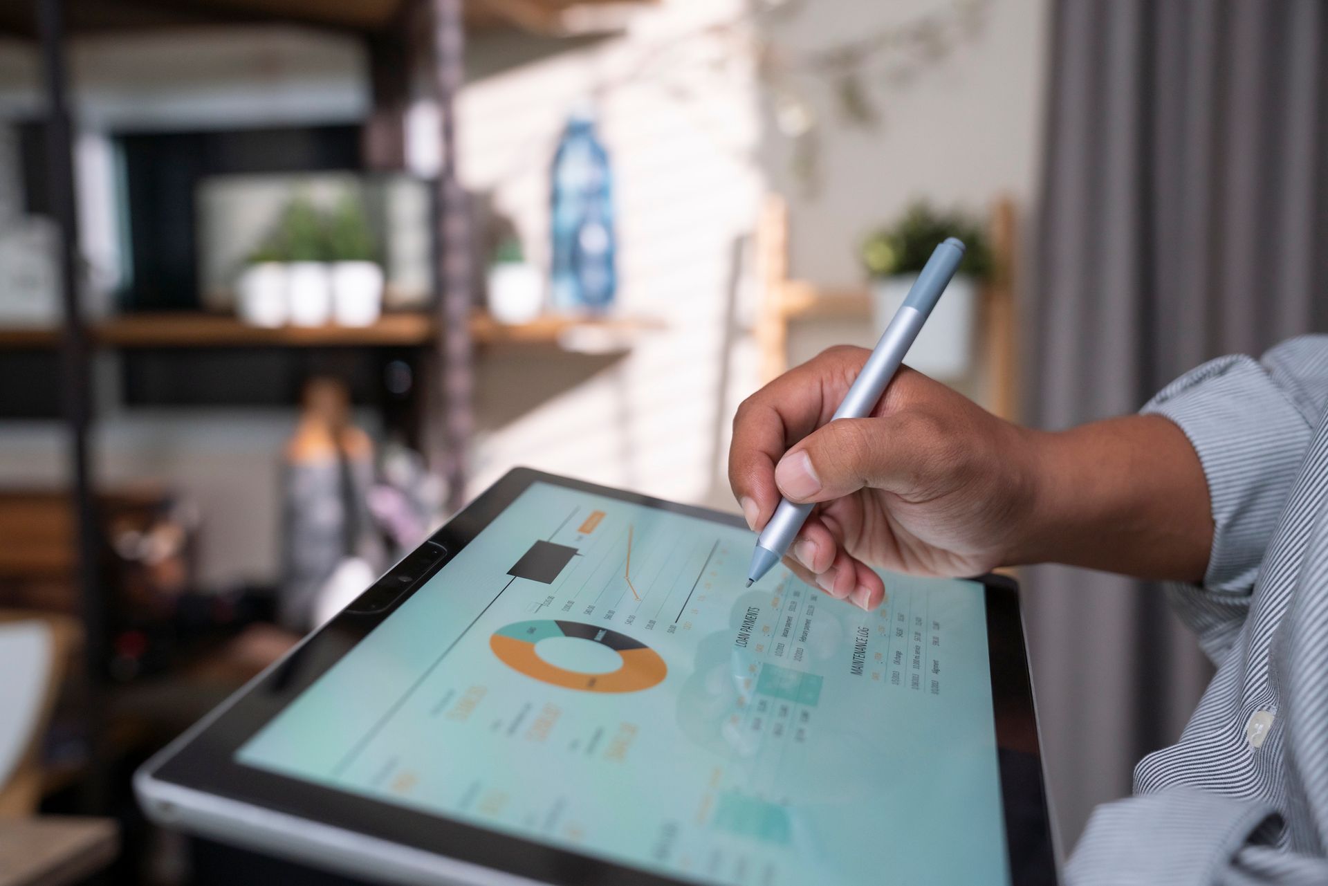 A person is writing on a tablet with a pen.