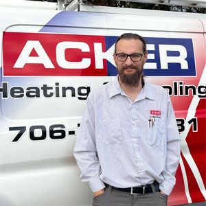 A man standing in front of an acker heating van
