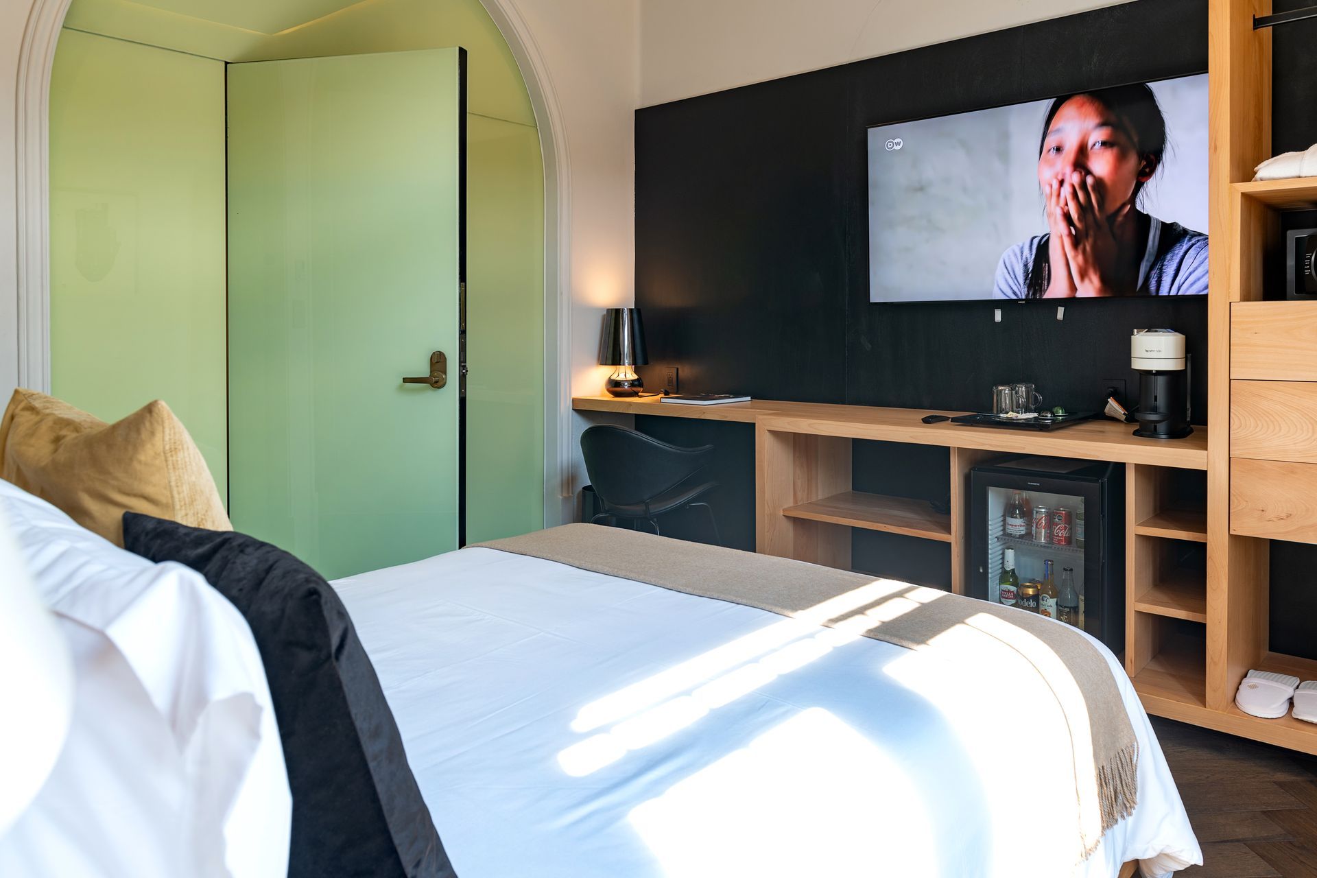 Una habitación de hotel con una cama y un televisor en la pared.