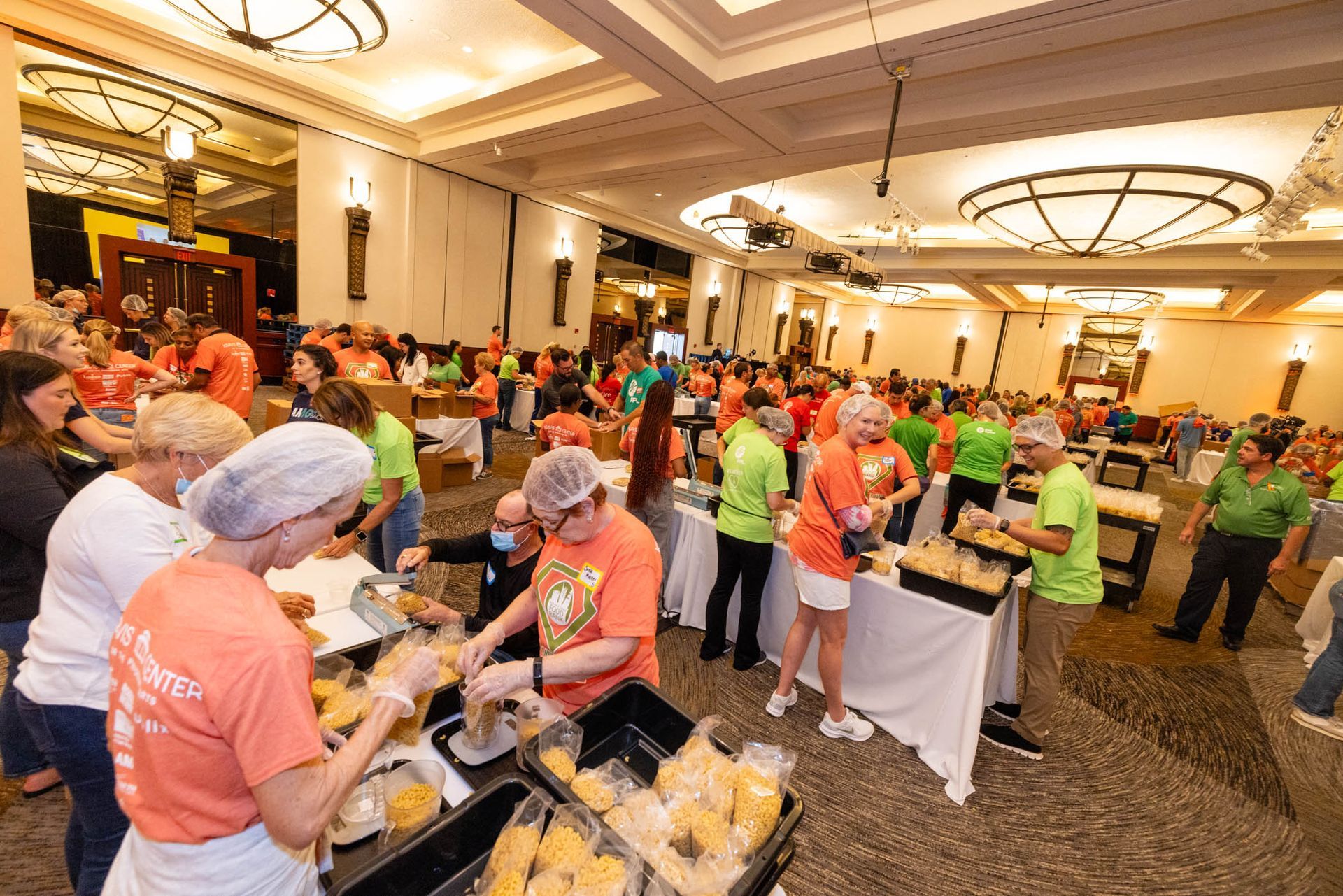 volunteers packing pasta meals at kravis center for the performing arts