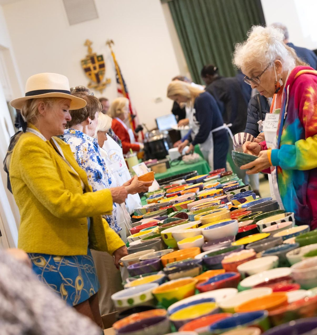 guests selecting hand-painted ceramic bowls at empty bowls palm beach
