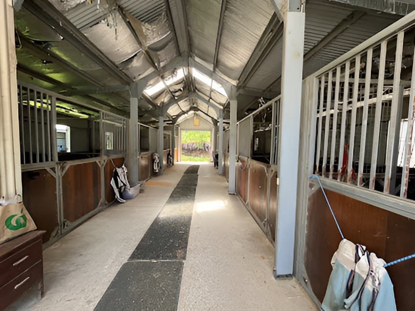 A Long Hallway in a Horse Stable With Lots of Stalls and a Roof — Merrypark Equestrian Centre In Eumundi, QLD