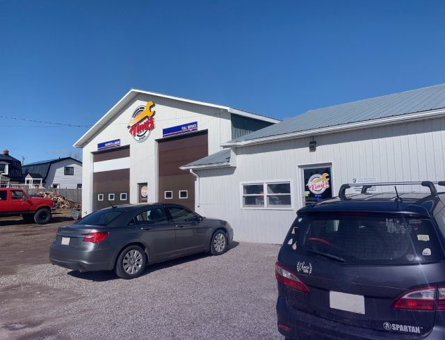 A garage with a sign that says ' hawks ' on it | Tiny's Automotive