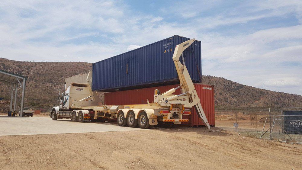 Two Containers Being Loaded On The Truck — Central Australian Sidelifter Haulage In Braitling NT