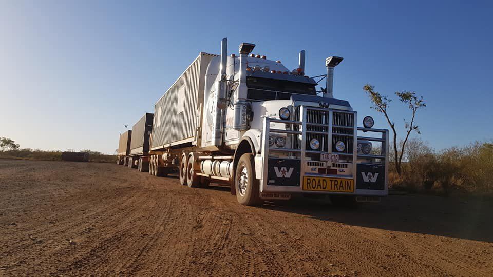 Road Train Truck With Three Containers On A Dirt Road — Central Australian Sidelifter Haulage In Braitling NT