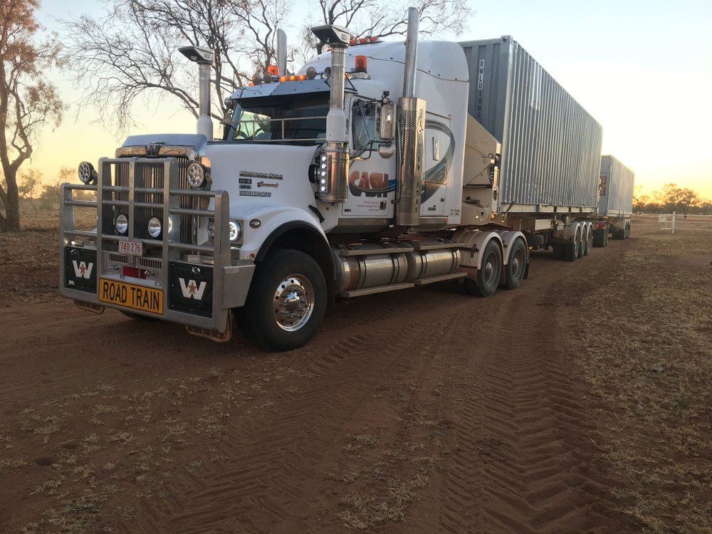 Road Train Truck Carrying Two Grey Containers — Central Australian Sidelifter Haulage In Braitling NT