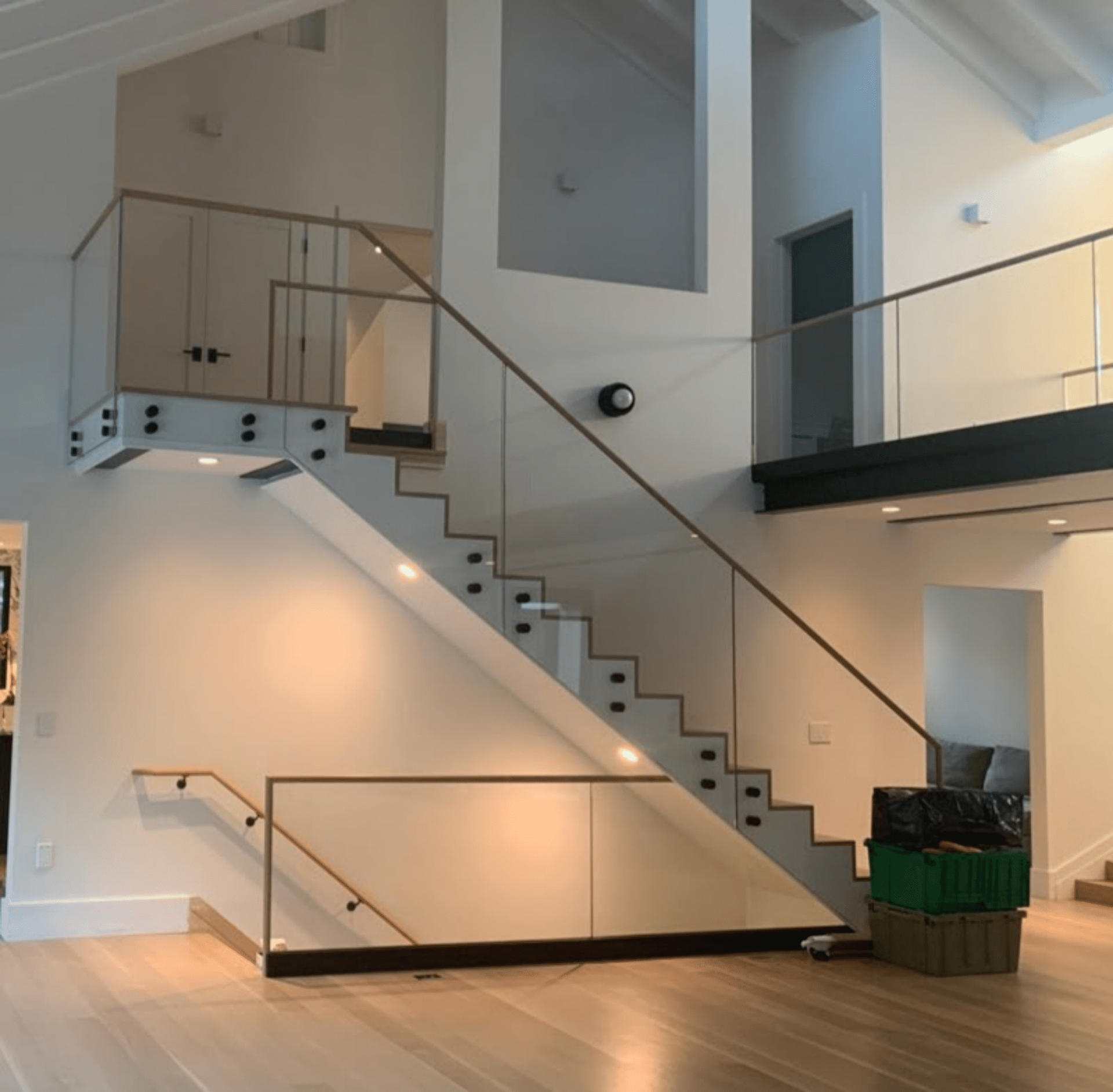 A bathroom with a walk in shower , sink , toilet and window.