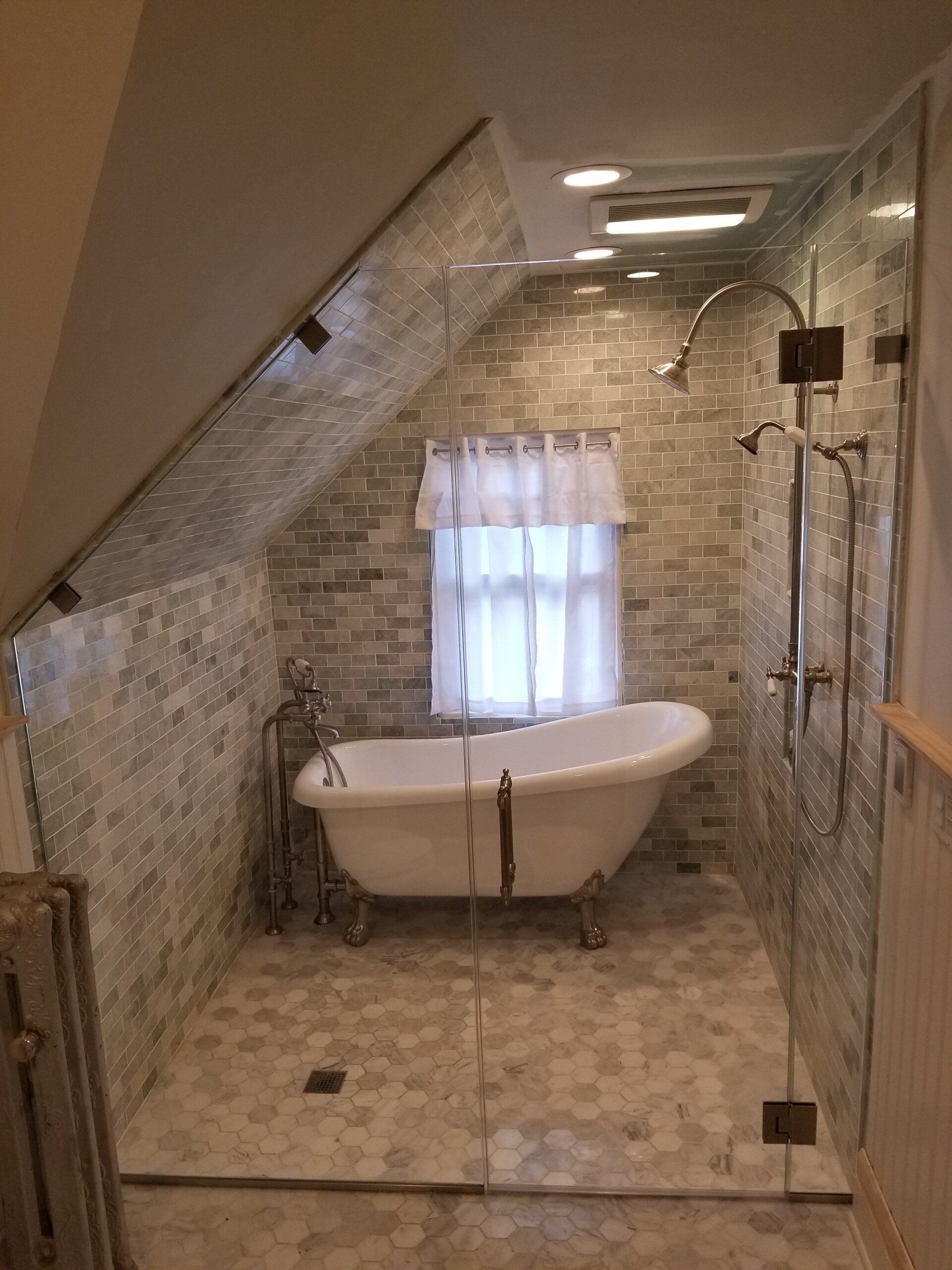 A bathroom with a claw foot tub and a walk in shower.