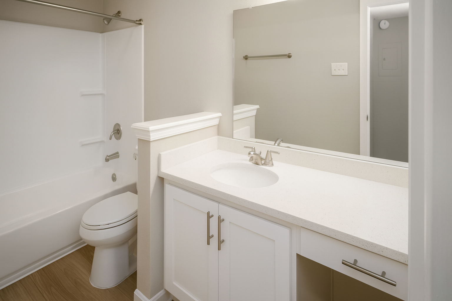White bathroom with a sink, toilet, and shower.