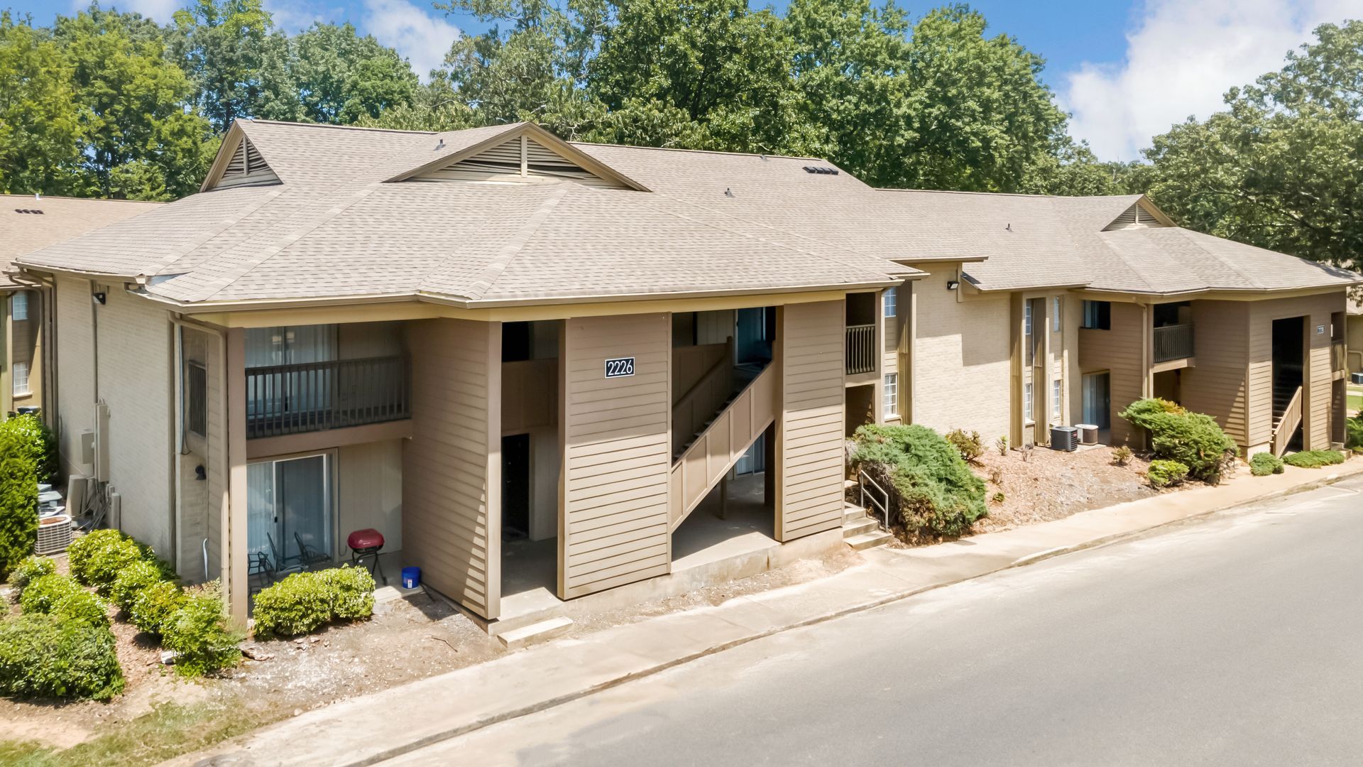A large apartment building with a staircase leading up to the second floor.