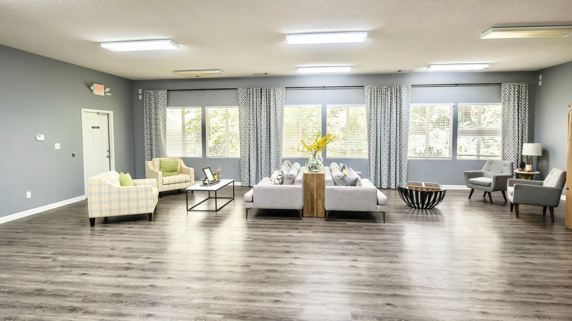 A living room filled with furniture and a lot of windows.