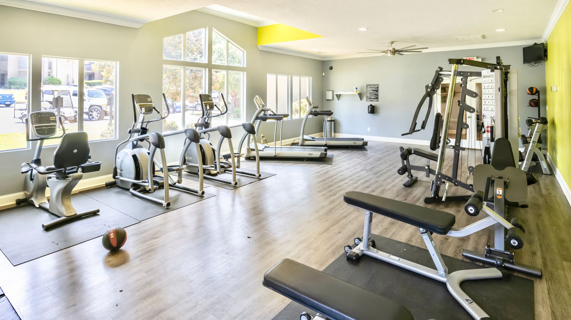 A large gym filled with lots of exercise equipment.