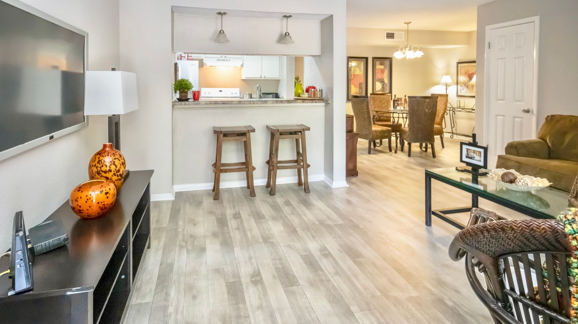 A living room with hardwood floors and a flat screen tv.