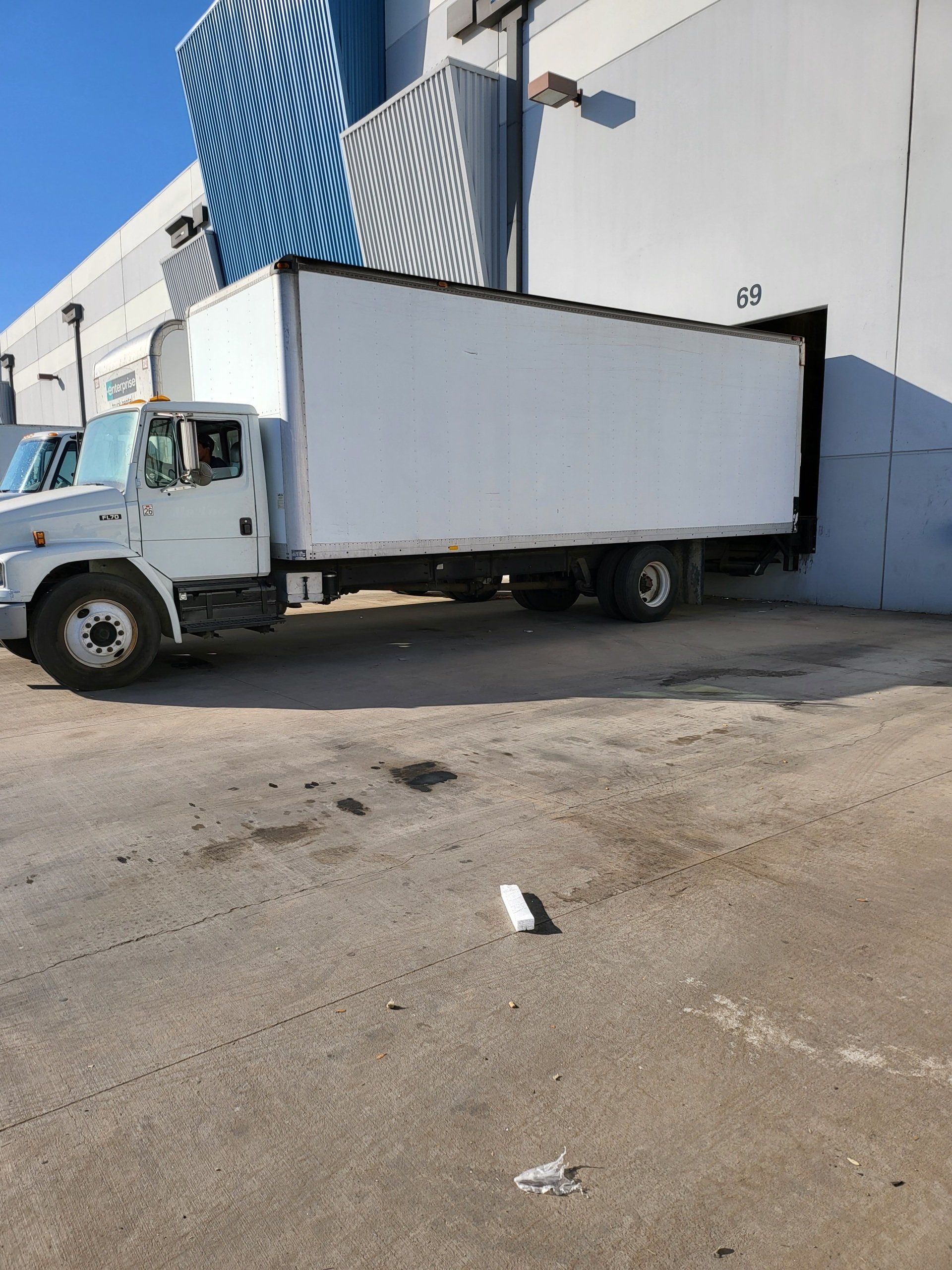 Green Valley box truck parked at warehouse loading dock.