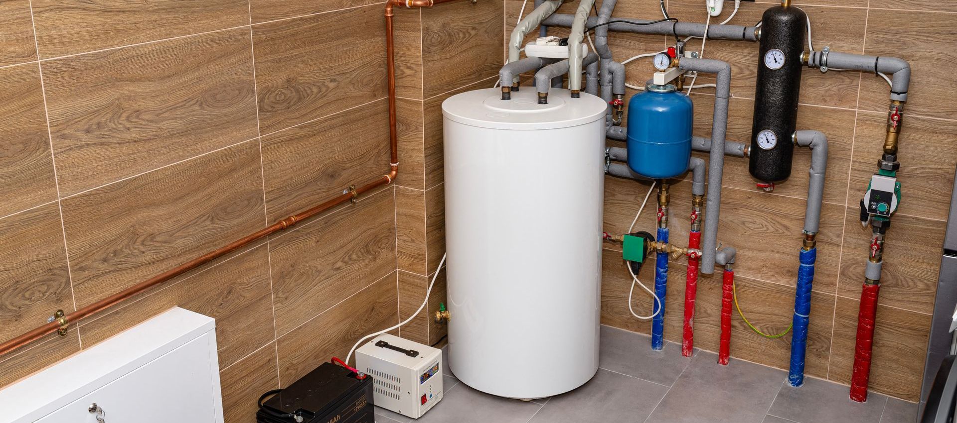 A basement with a water heater and a furnace.