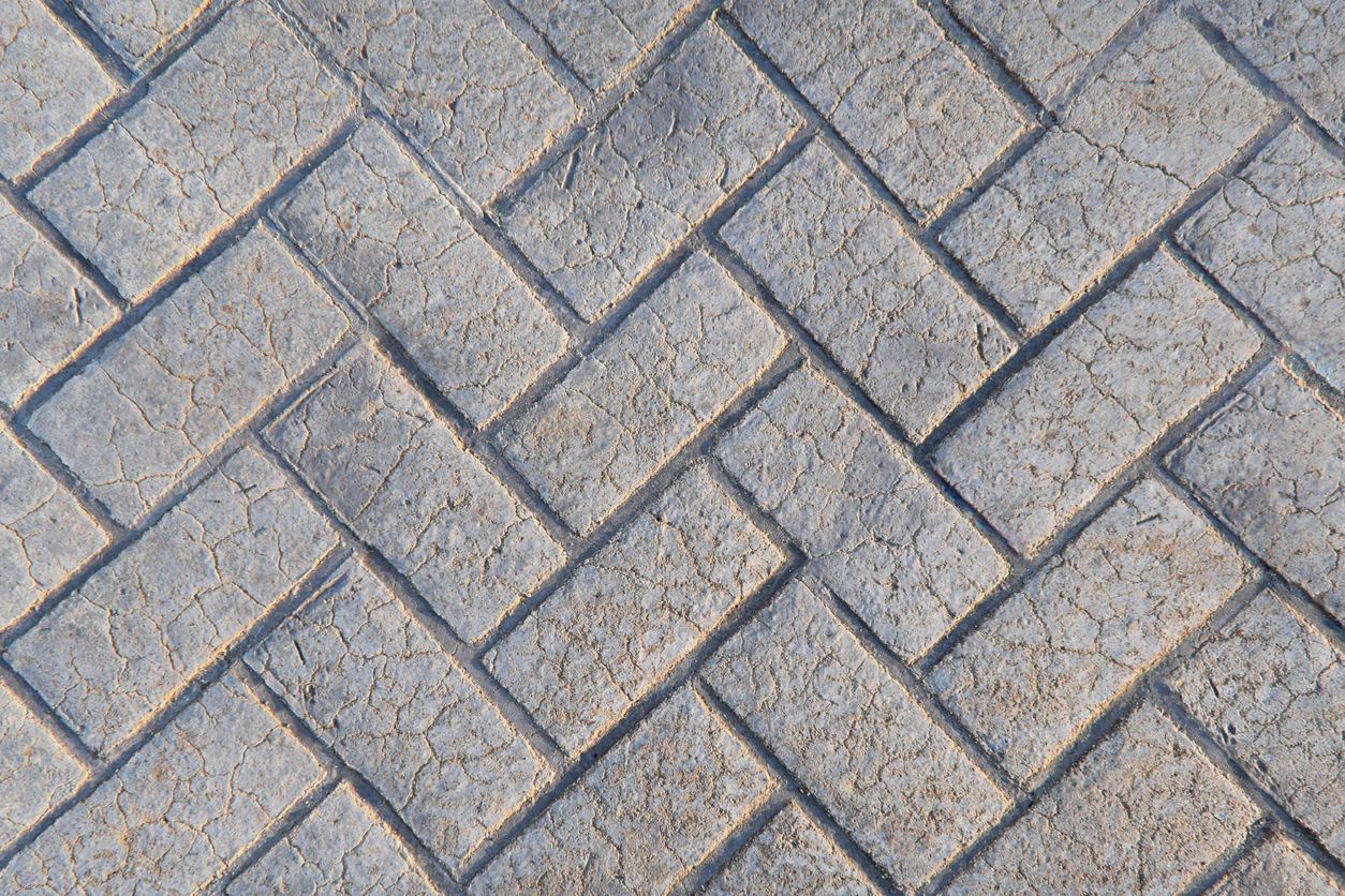 Herringbone brick pattern, gray bricks laid in diagonal rows.