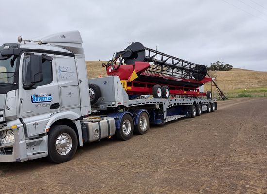 Truck Transporting Large Red Vehicle — Towing in Ballarat , VIC
