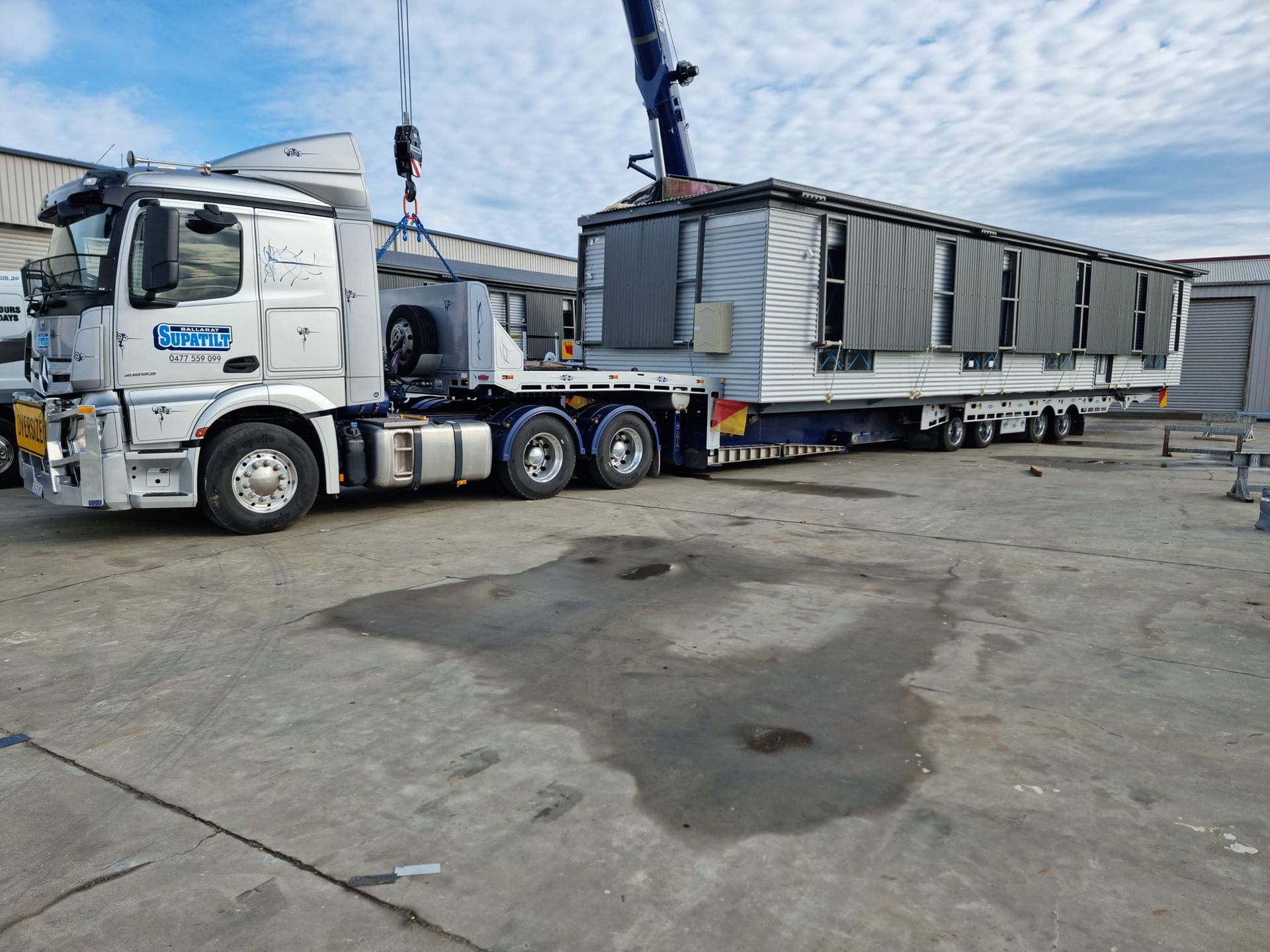 A truck is carrying a trailer with a crane attached to it — Ballarat Supatilt in Delacombe, VIC