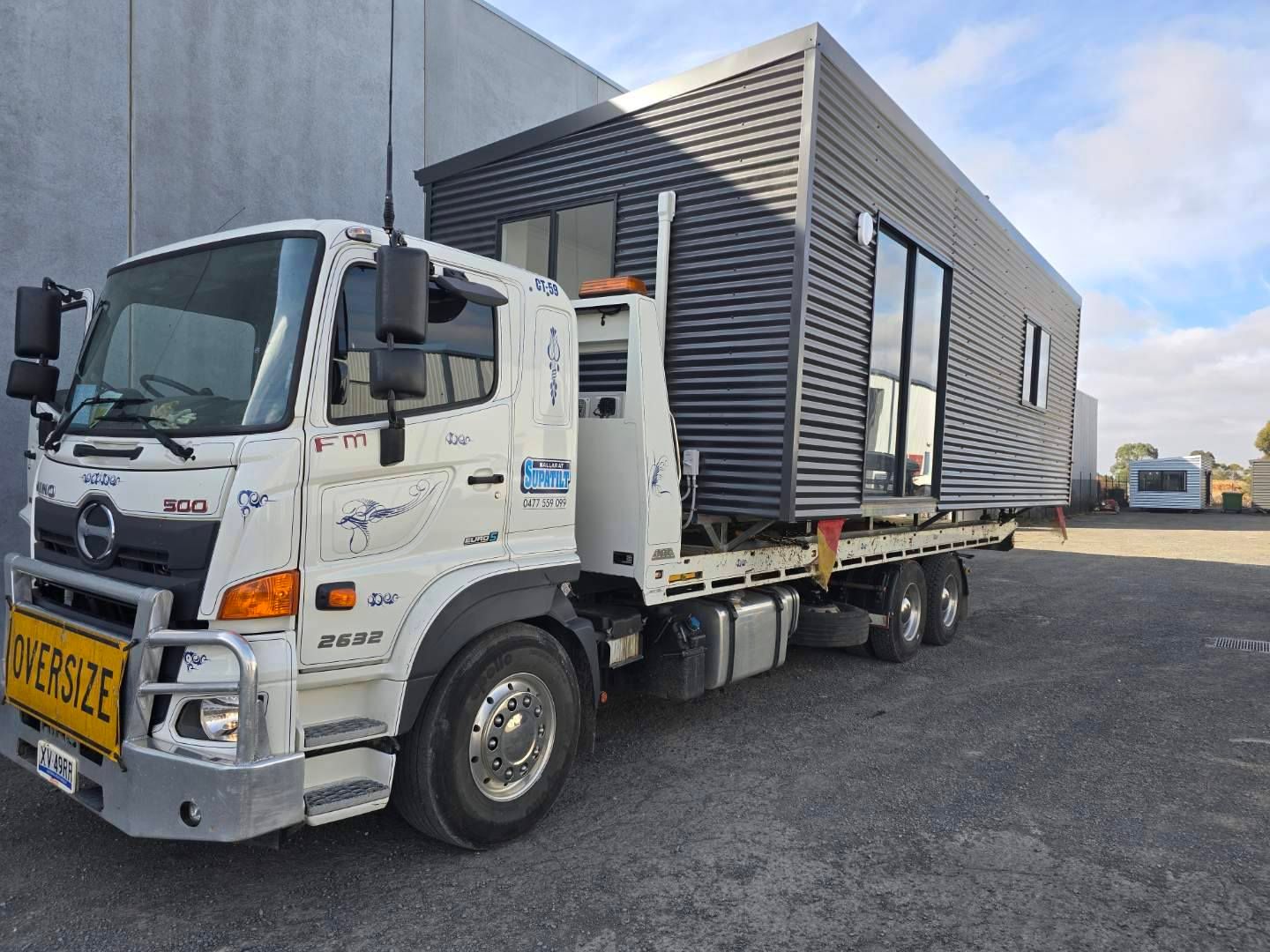 A tow truck is carrying a small house on the back of it — Ballarat Supatilt in Delacombe, VIC