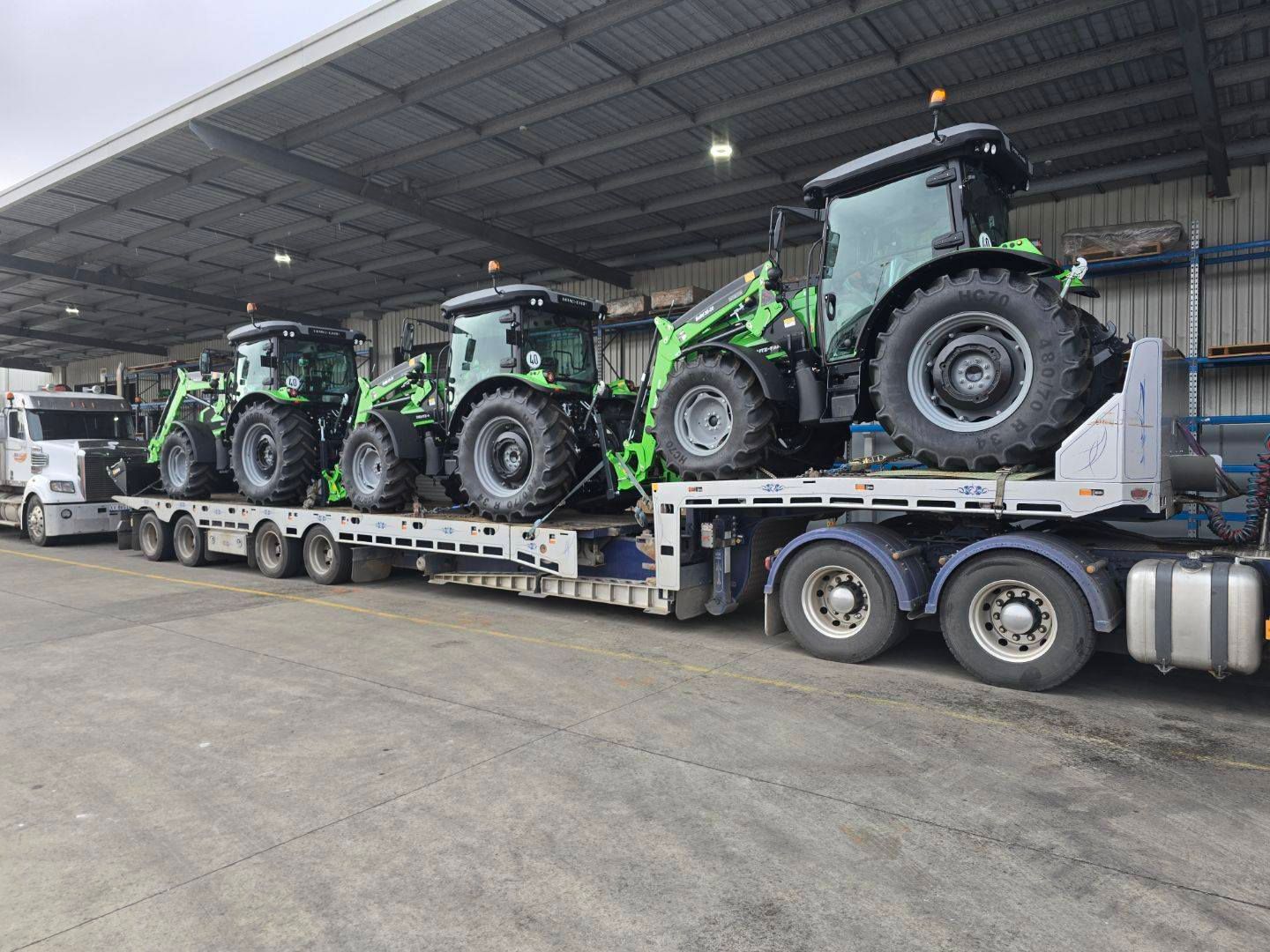 A truck is carrying a row of tractors on a trailer — Ballarat Supatilt in Delacombe, VIC