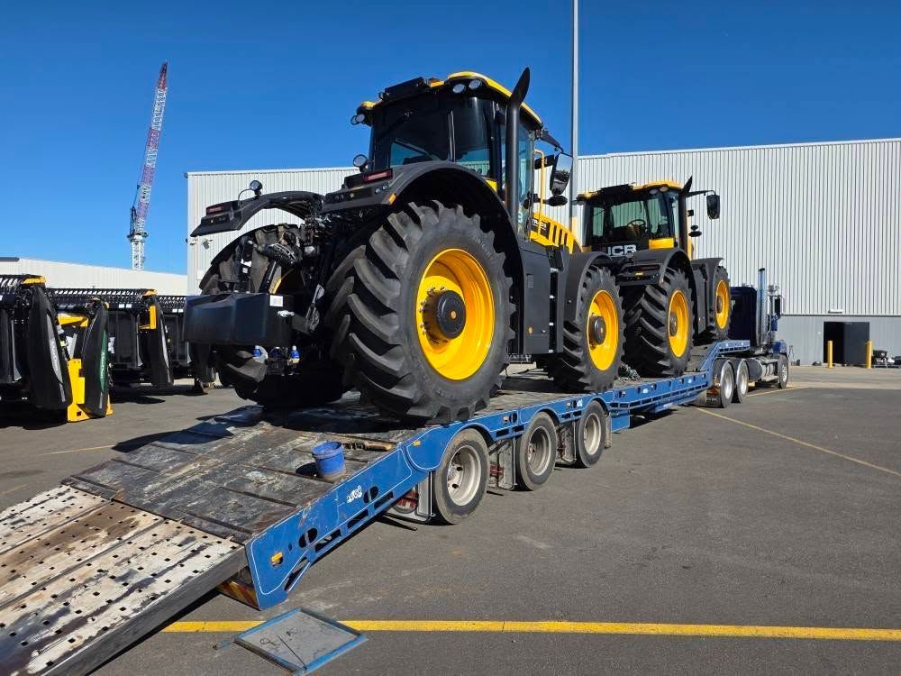 A Tow Truck With a Tractor on the Back is Parked on the Side of the Road — Ballarat Supatilt in Bendigo, VIC