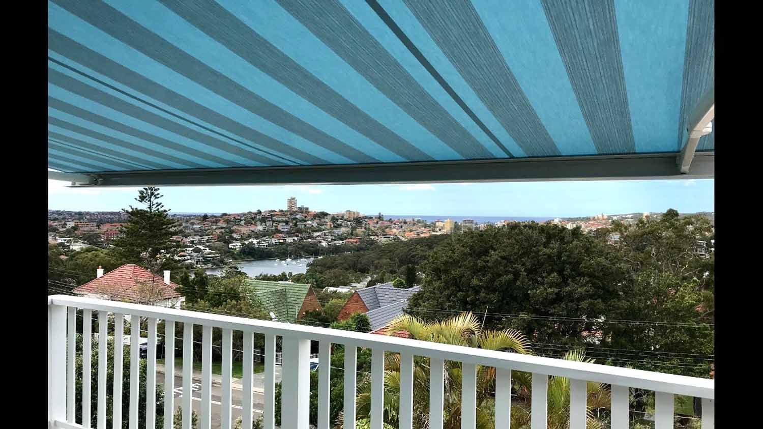 A blue and grey striped awning over a white railing | Sydney, NSW | Sunmaster Australia