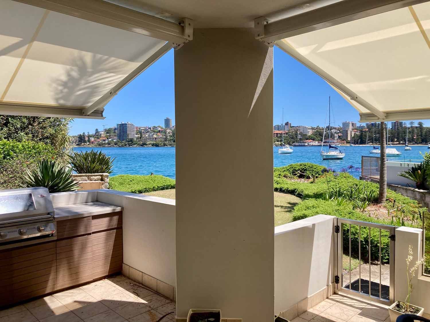 A patio with a view of the water and a city | Sydney, NSW | Sunmaster Australia