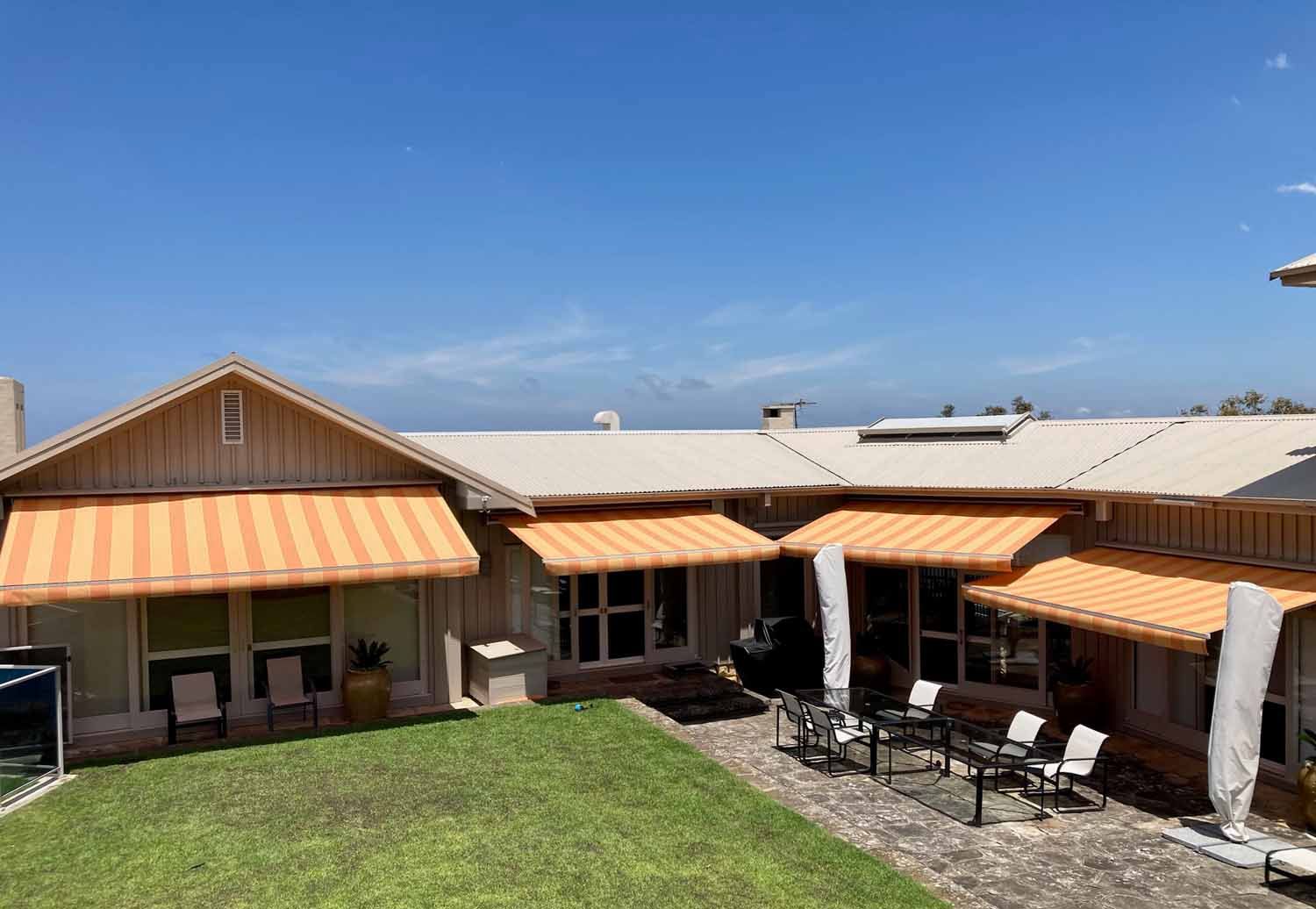 A house with a lawn and chairs | Sydney, NSW | Sunmaster Australia