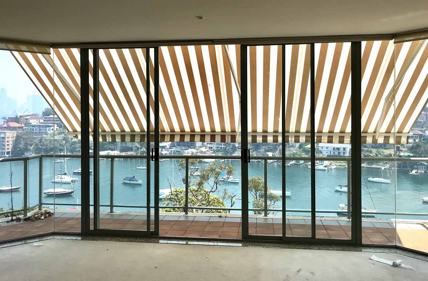 A room with glass doors and a view of water and boats | Sydney, NSW | Sunmaster Australia