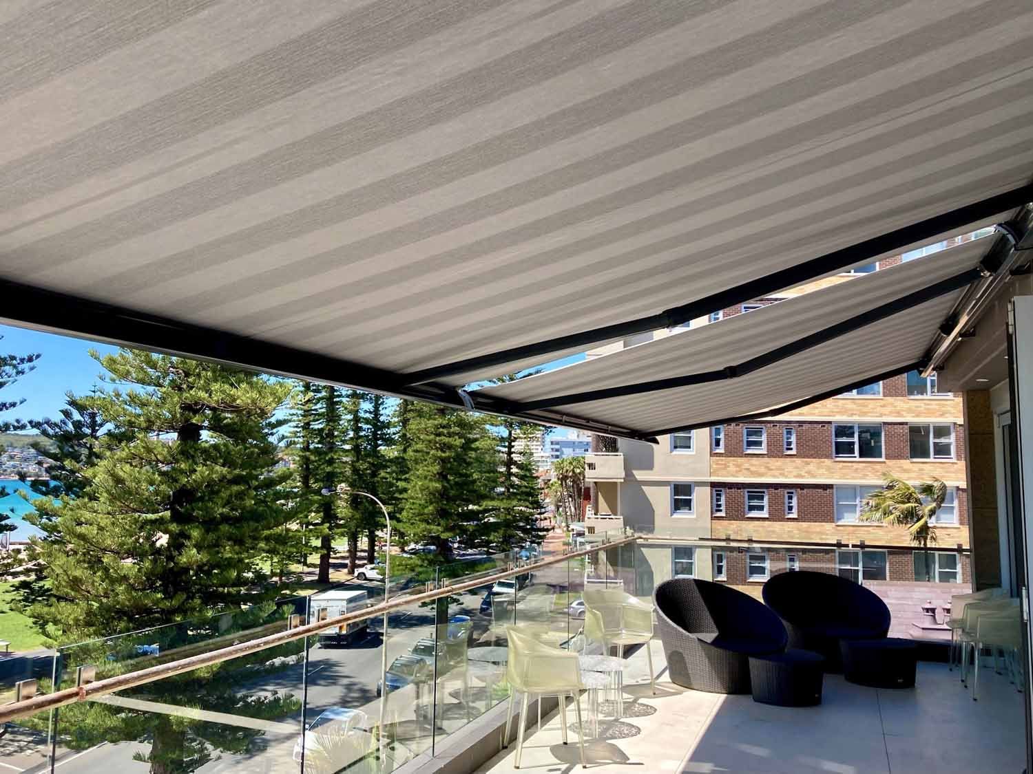 A patio with chairs and a glass railing | Sydney, NSW | Sunmaster Australia