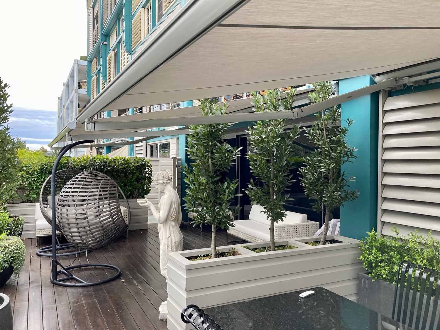 A patio with a white bench and small trees | Sydney, NSW | Sunmaster Australia