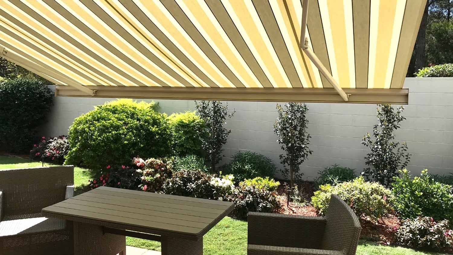 A table and chairs under grey and yellow awning | Sydney, NSW | Sunmaster Australia