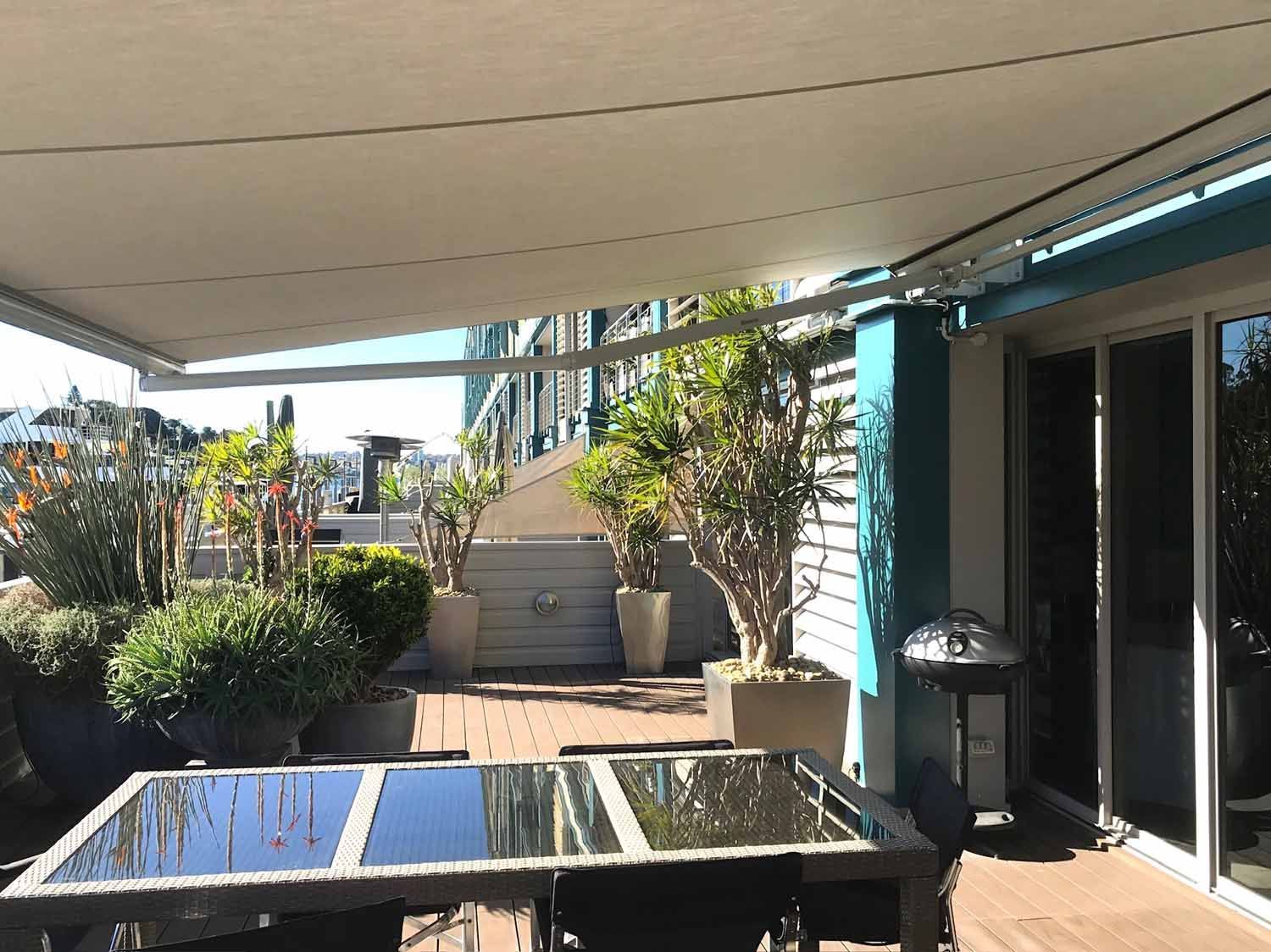 A patio with a glass top table | Sydney, NSW | Sunmaster Australia