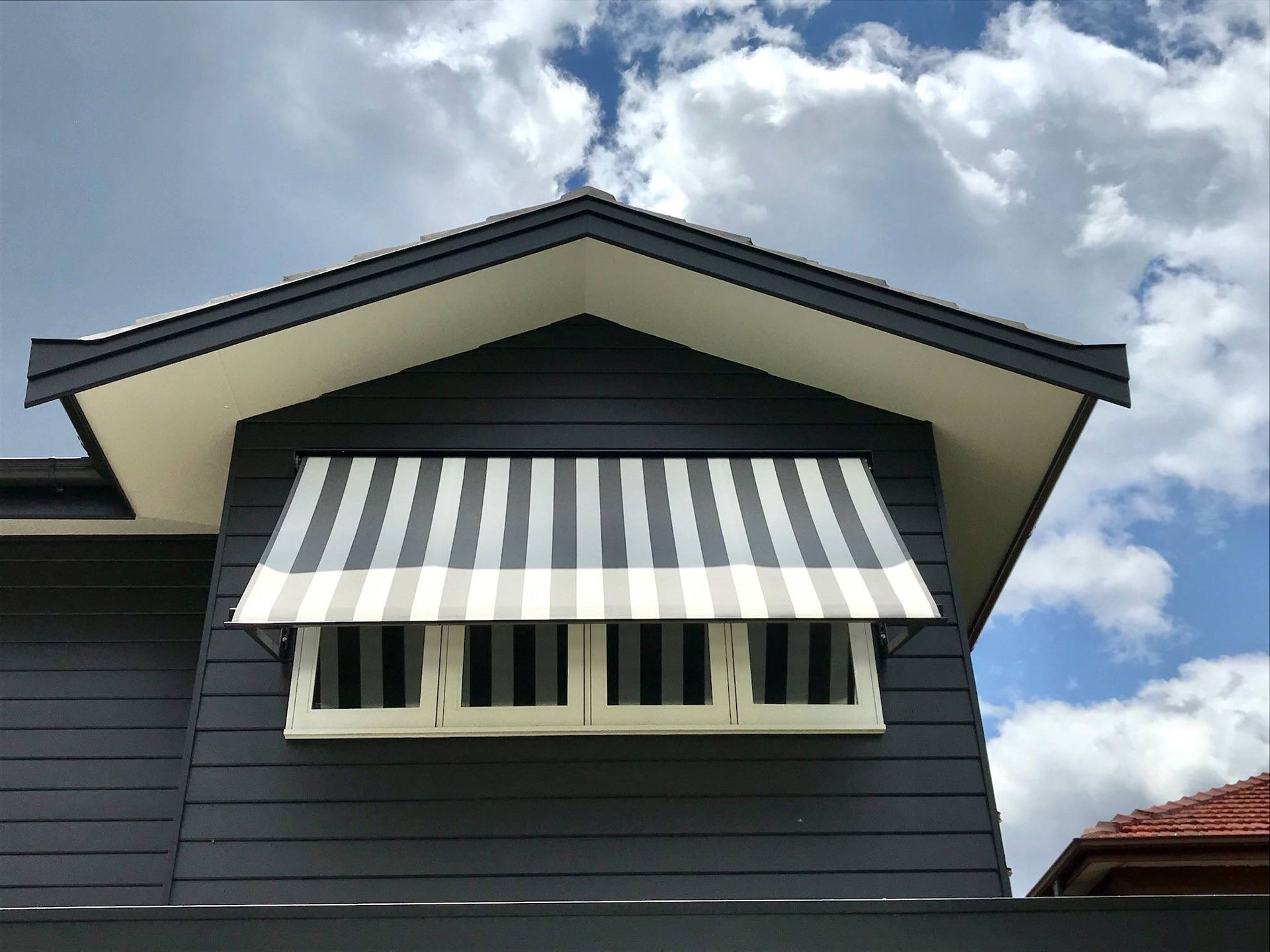 A black and white striped awning on a house | Sydney, NSW | Sunmaster Australia