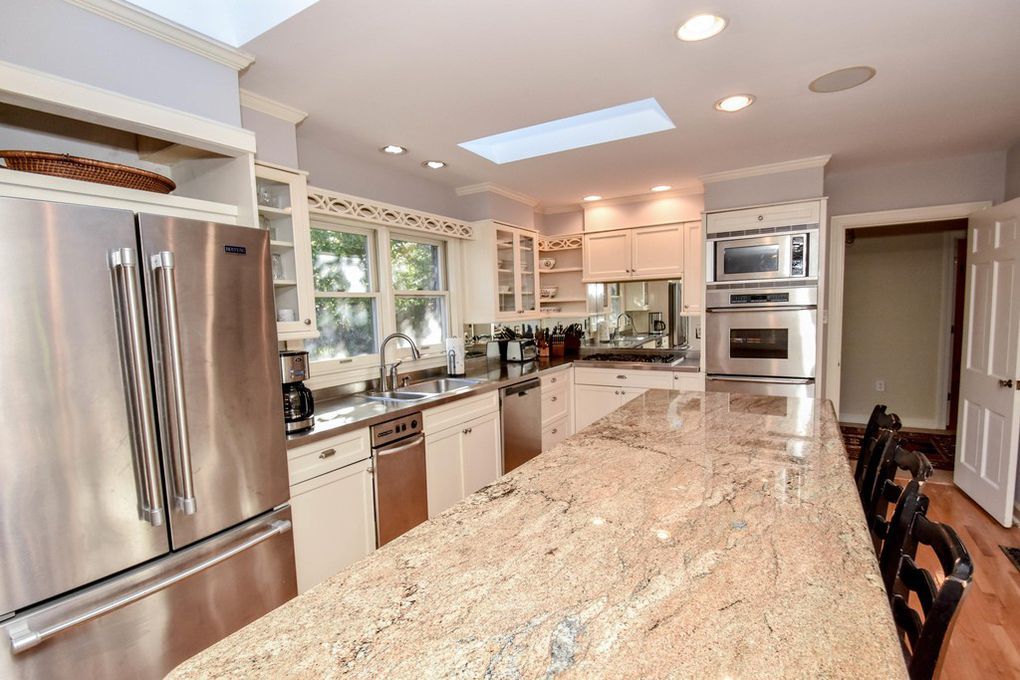A kitchen with granite counter tops and stainless steel appliances