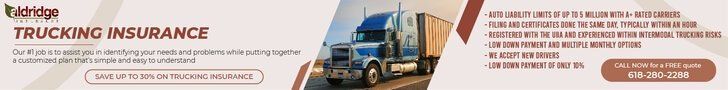A blue truck is driving down a road next to a sign that says trucking insurance.