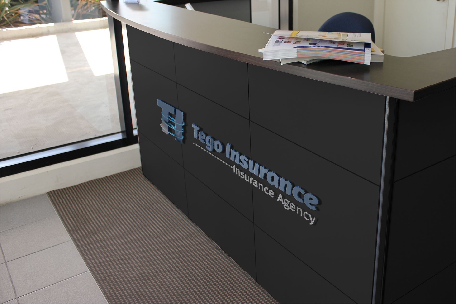 A black desk with the logo for tego insurance on it