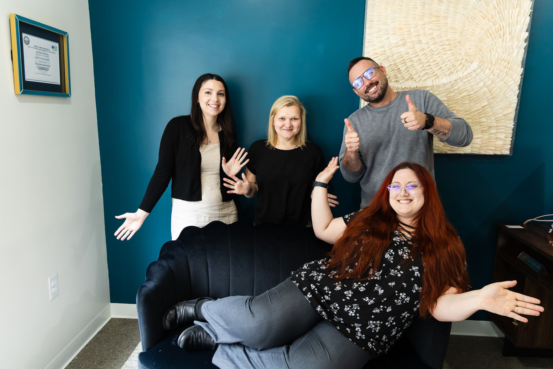 A group of people are posing for a picture in a room.