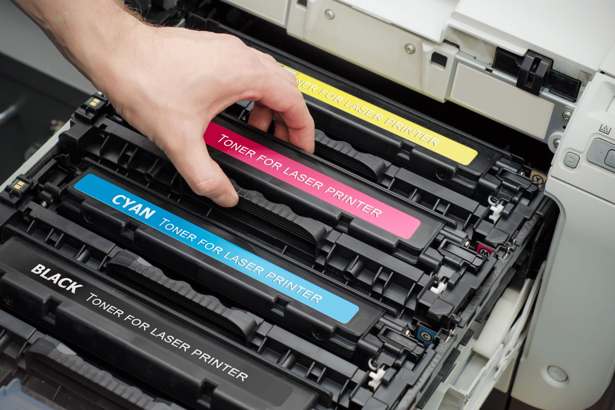 Wire baskets on sliding tracks inside a white closet, holding folded scarves and yarn.