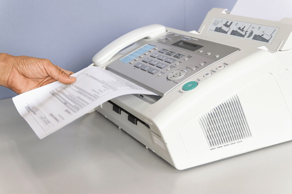 Wire baskets on sliding tracks inside a white closet, holding folded scarves and yarn.